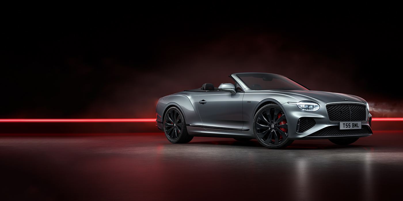 Bentley Copenhagen Bentley Continental GTC Black Edition convertible front three quarters in Hallmark silver against a dark grey and red background