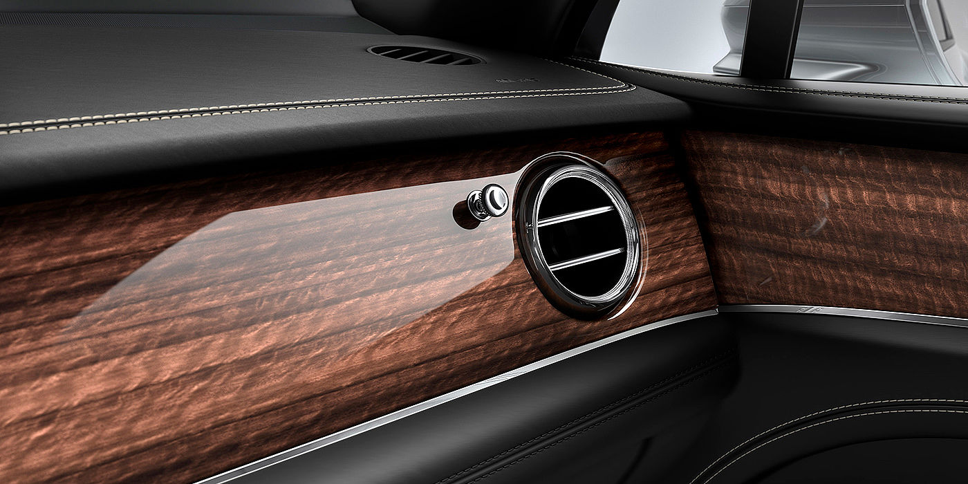 Bentley Copenhagen Bentley Bentayga front interior Crown Cut Walnut veneer and chrome air vent.