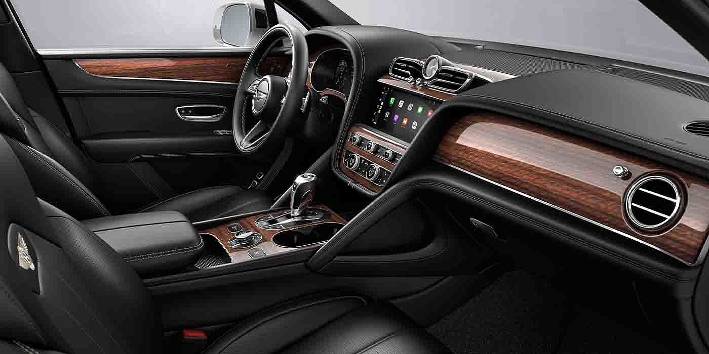Bentley Copenhagen Bentley Bentayga EWB interior with a Crown Cut Walnut veneer, view from the passenger seat over looking the driver's seat.