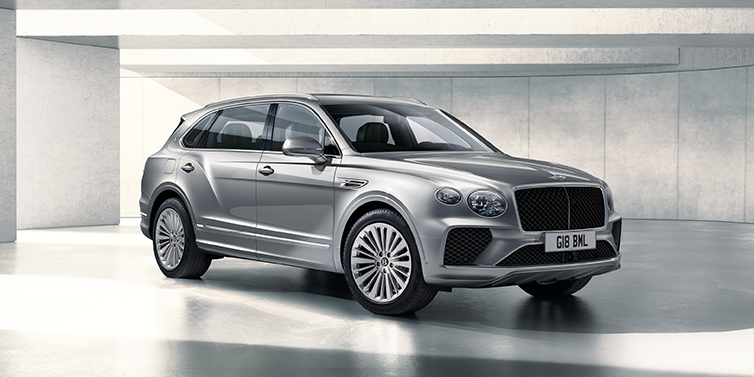 Bentley Copenhagen Bentley Bentayga Extended Wheelbase SUV front three quarter in Moonbeam paint with a grey background