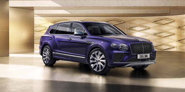 Bentley Copenhagen Bentley Bentayga Extended Wheelbase Mulliner SUV front three quarter in Tanzanite Purple paint with a gold patterned background