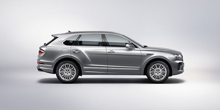 Bentley Copenhagen Bentley Bentayga SUV side profile in Moonbeam silver paint against white background featuring 21 inch 5 spoke wheels