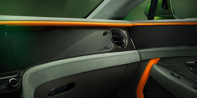 Bentley Copenhagen Bentley Continental GT Speed coupe front interior dash detail with high gloss carbon fibre veneer surrounded by Mandarin by Mulliner and Gravity Grey hides