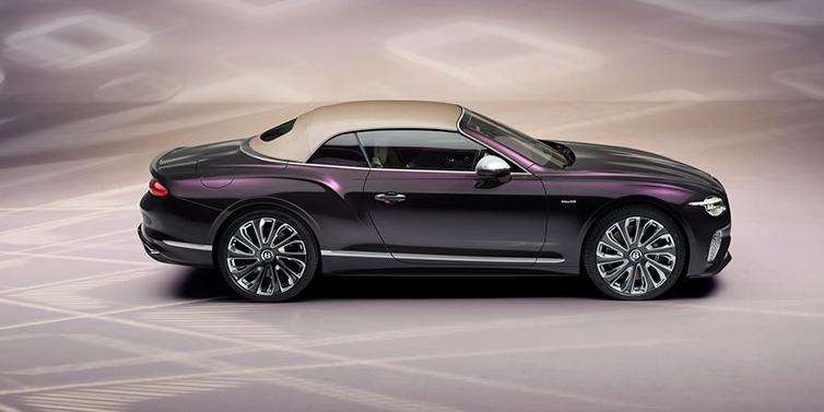 Bentley Copenhagen Bentley Continental GTC Mulliner convertible in profile with hood up, in Tanzanite Purple paint and 22 inch Mulliner painted and polished wheels