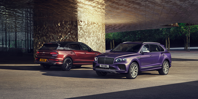 Bentley Copenhagen A duo of Bentley Bentayga Extended Wheelbase Mulliner SUVs parked in a city environment, with Tanzanite Purple and Cricket Ball red exterior paint