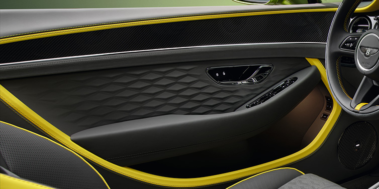 Bentley Copenhagen Bentley Continental GTC Speed convertible interior door details featuring Gravity Grey and Cyber Yellow by Mulliner hides and high gloss carbon fibre veneer