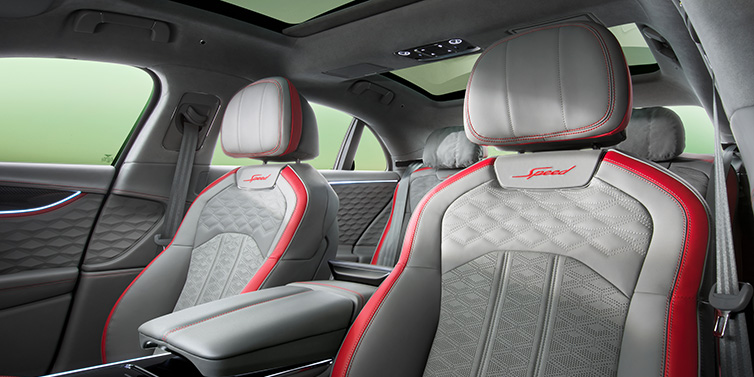 Bentley Copenhagen Bentley Flying Spur Speed sedan interior showing front and rear seats in Hotspur red and Gravity Grey hides, with Speed seat emblems