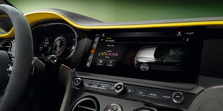 Bentley Copenhagen Bentley Continental GTC Speed convertible front interior centre console with MMI screen showing Air Quality visualisation surrounded by Cyber Yellow by Mulliner and Gravity Grey hides and high gloss carbon fibre veneer